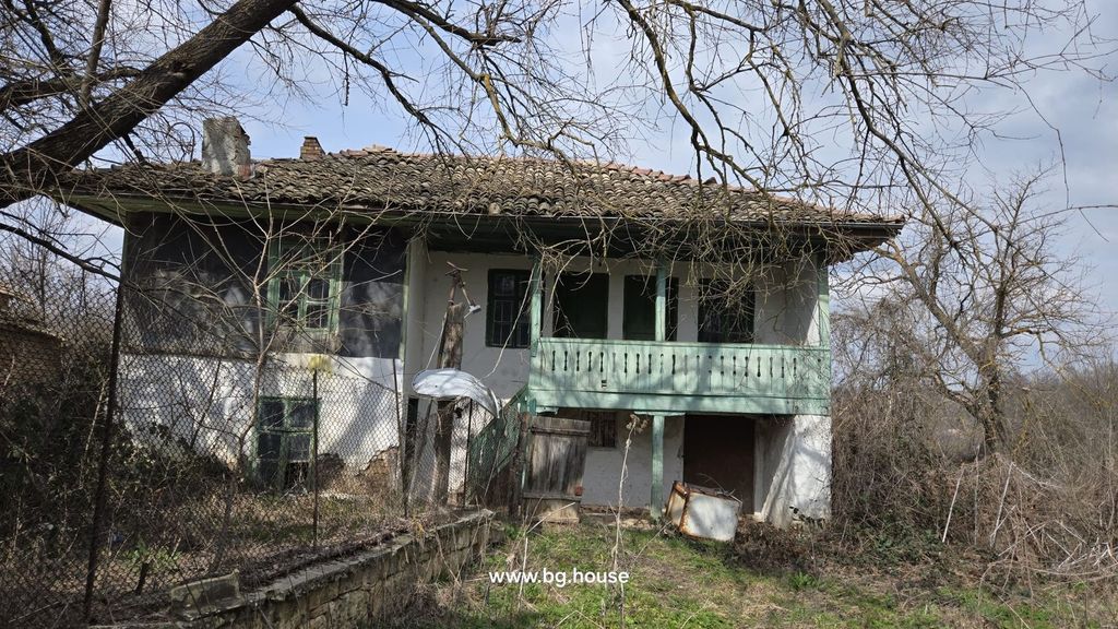 Property photo 1 of 49 Exterior View Of An Old Rural House Featuring A Tiled Roof And A Green Wooden Balcony With Surrounding Leafless Trees And Wire Fence.