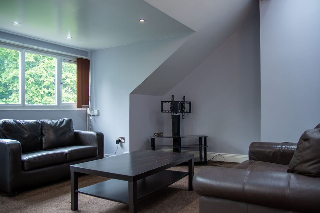 Property photo 1 of 6 Spacious And Bright Living Room Featuring Two Comf...