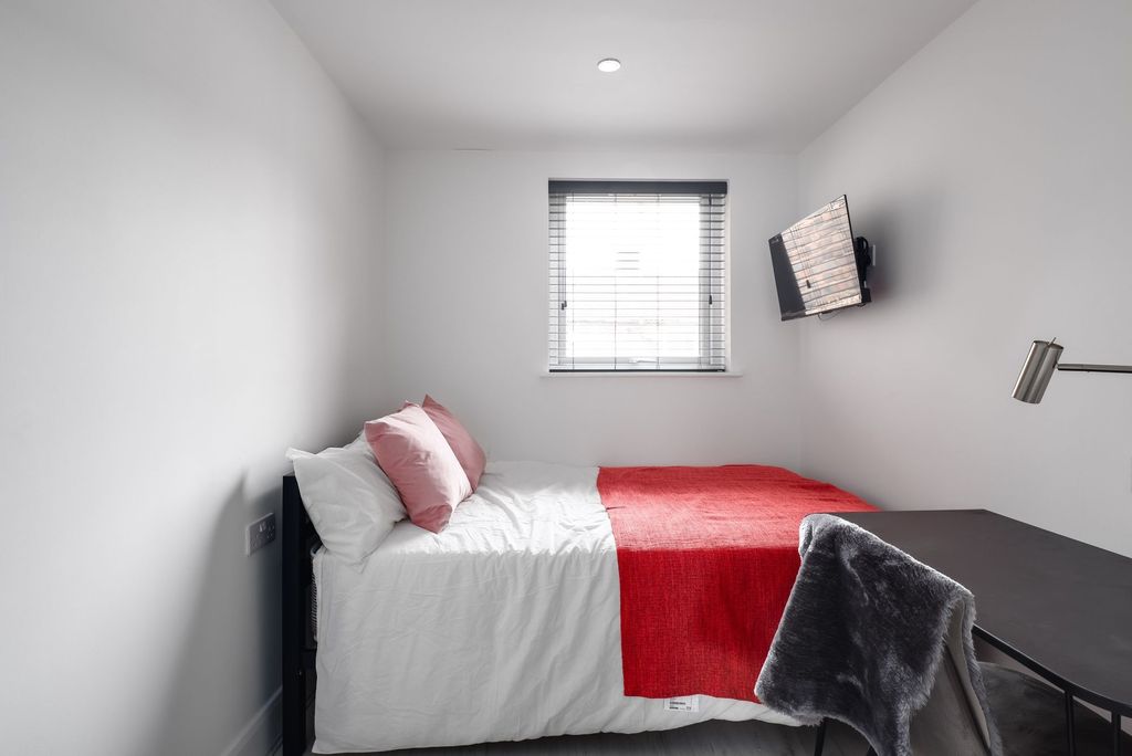 Property photo 3 of 3 A Well-Lit, Minimalist Bedroom Featuring A Comfort...