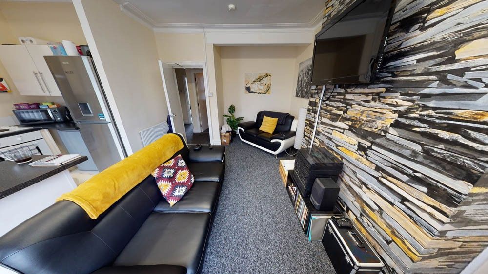 Property photo 3 of 9 A Comfortable Living Room Featuring Modern Black S...