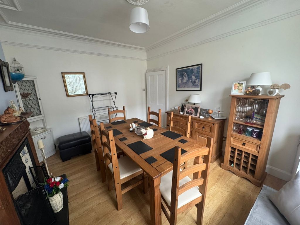 Property photo 1 of 8 A Cozy Living Room Featuring A Wooden Dining Table...