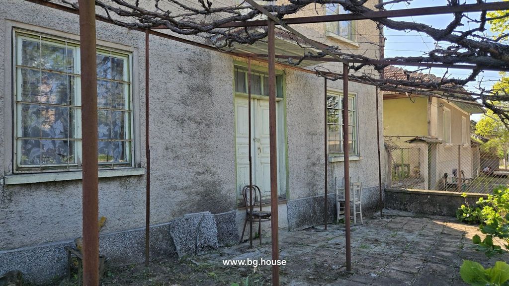 Property photo 2 of 37 Side Entrance Of The House With An Old Wooden Door And Metal Trellis Overhead.