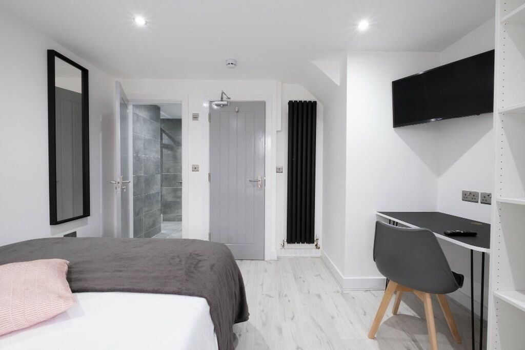 Property photo 3 of 15 This Stylish Double Bedroom Features Modern Decor,...