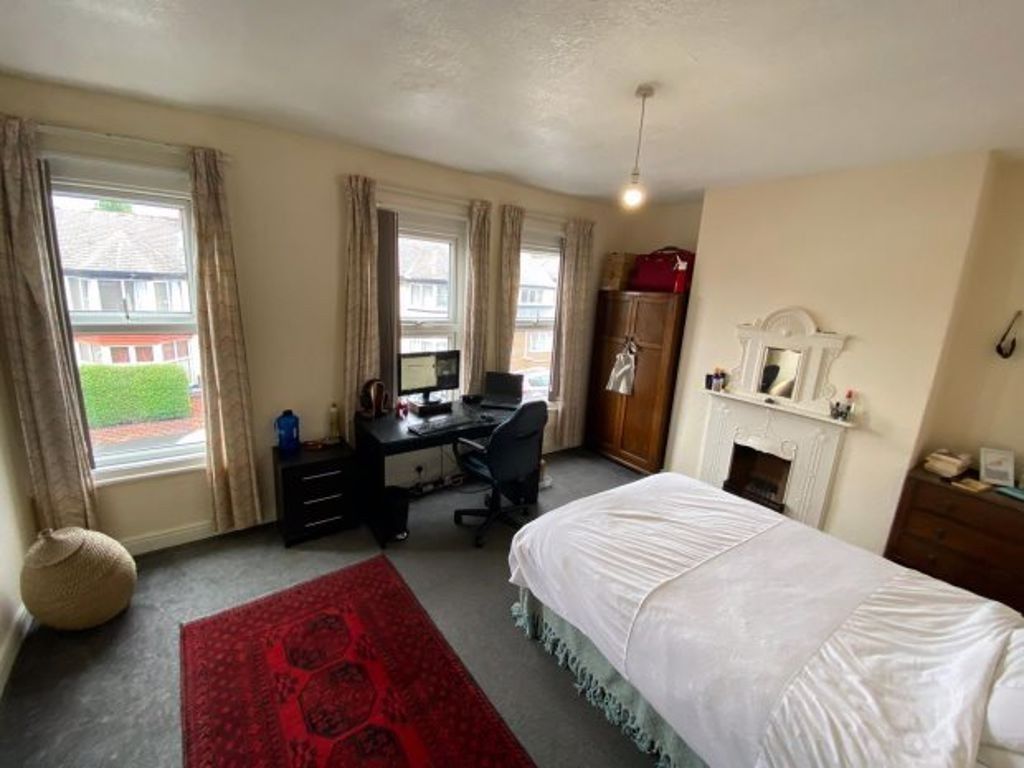 Property photo 1 of 21 A Spacious And Bright Bedroom Featuring Large Wind...