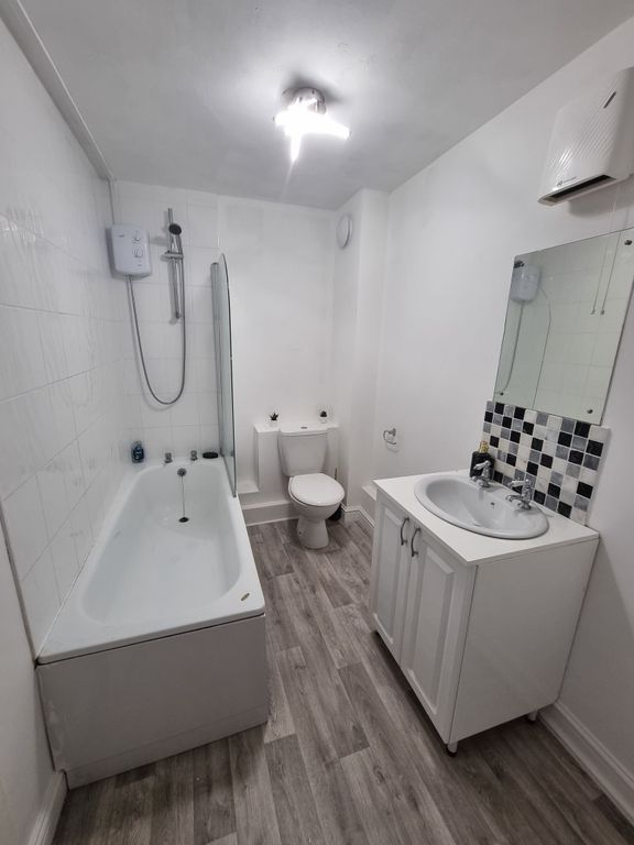 Property photo 3 of 5 Bright And Clean Bathroom Featuring A Bathtub, Toi...