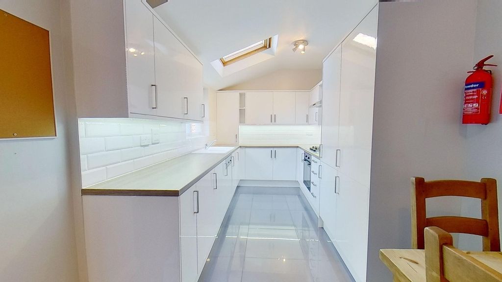 Property photo 2 of 11 Bright, Modern Galley Kitchen With High-Gloss Whit...