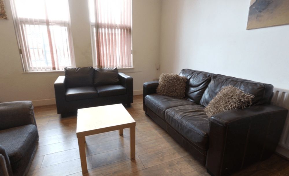 Property photo 2 of 13 A Well-Lit, Inviting Living Room Featuring Comfort...