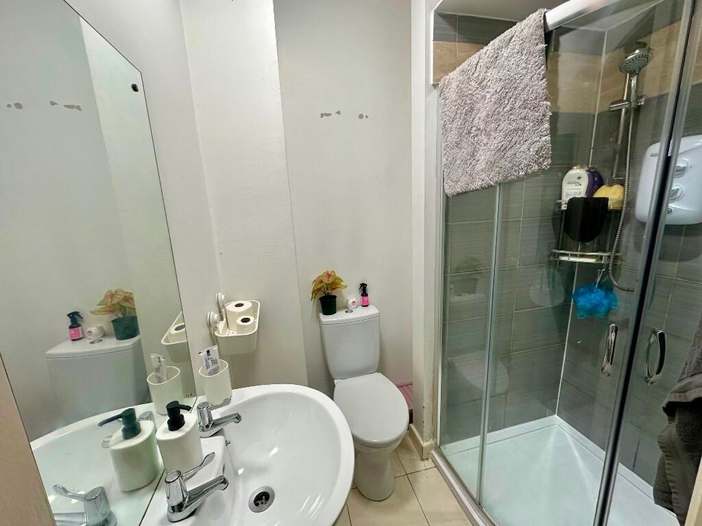 Property photo 3 of 14 Bright And Modern Bathroom Featuring A Spacious Sh...