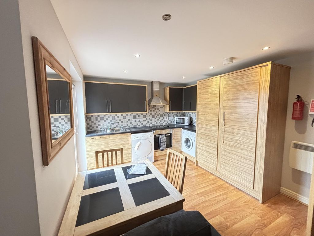 Property photo 2 of 9 A Bright And Modern Living Room Featuring A Cozy S...