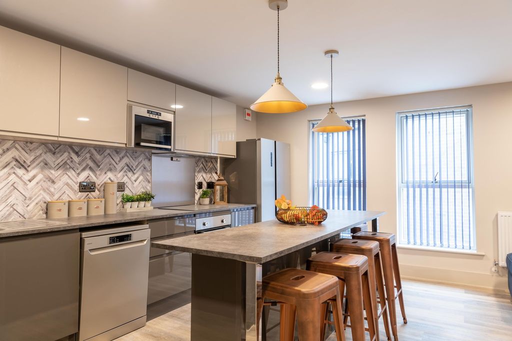Property photo 2 of 5 Modern Kitchen With Breakfast Bar And Sleek Units...