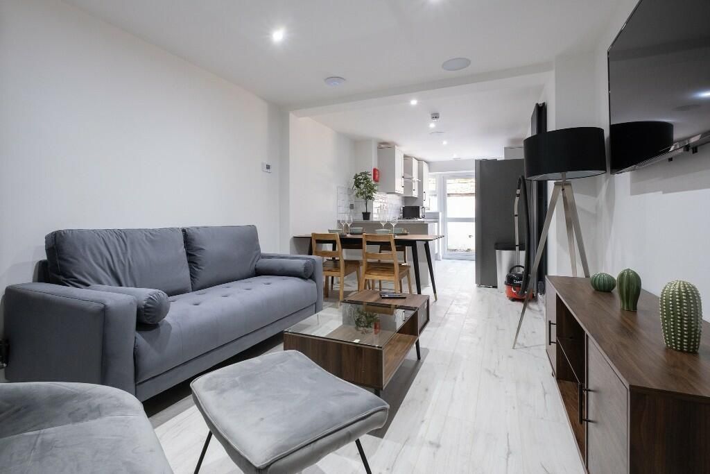 Property photo 3 of 15 Contemporary Living Room Featuring Stylish Grey Se...