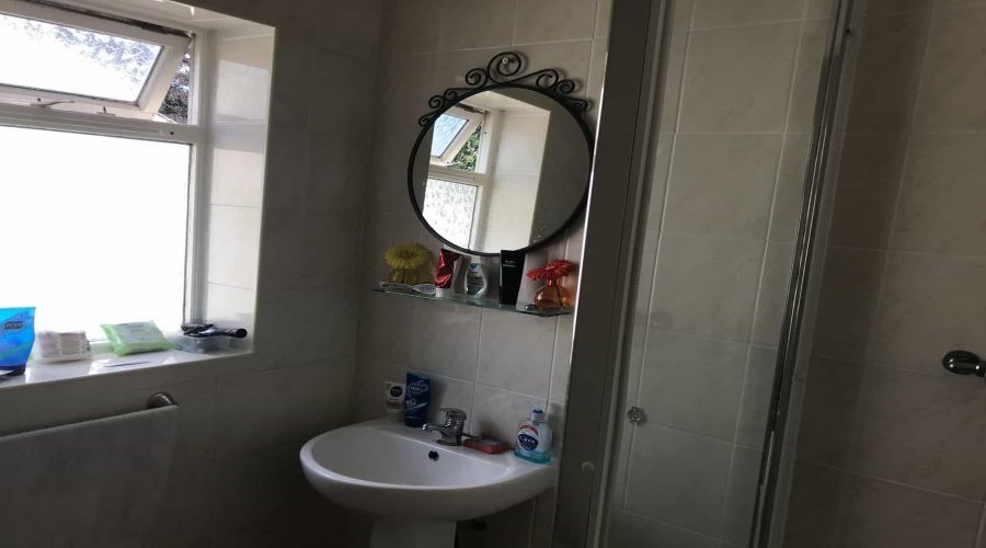 Property photo 2 of 5 A Neat Bathroom Featuring A White Sink With A Roun...