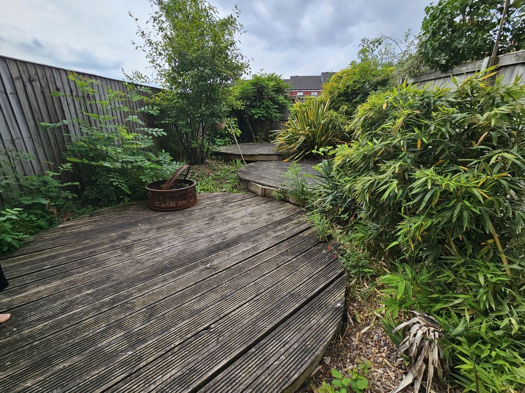 Property photo 3 of 18 A Charming Garden Space Featuring Tiered Wooden De...