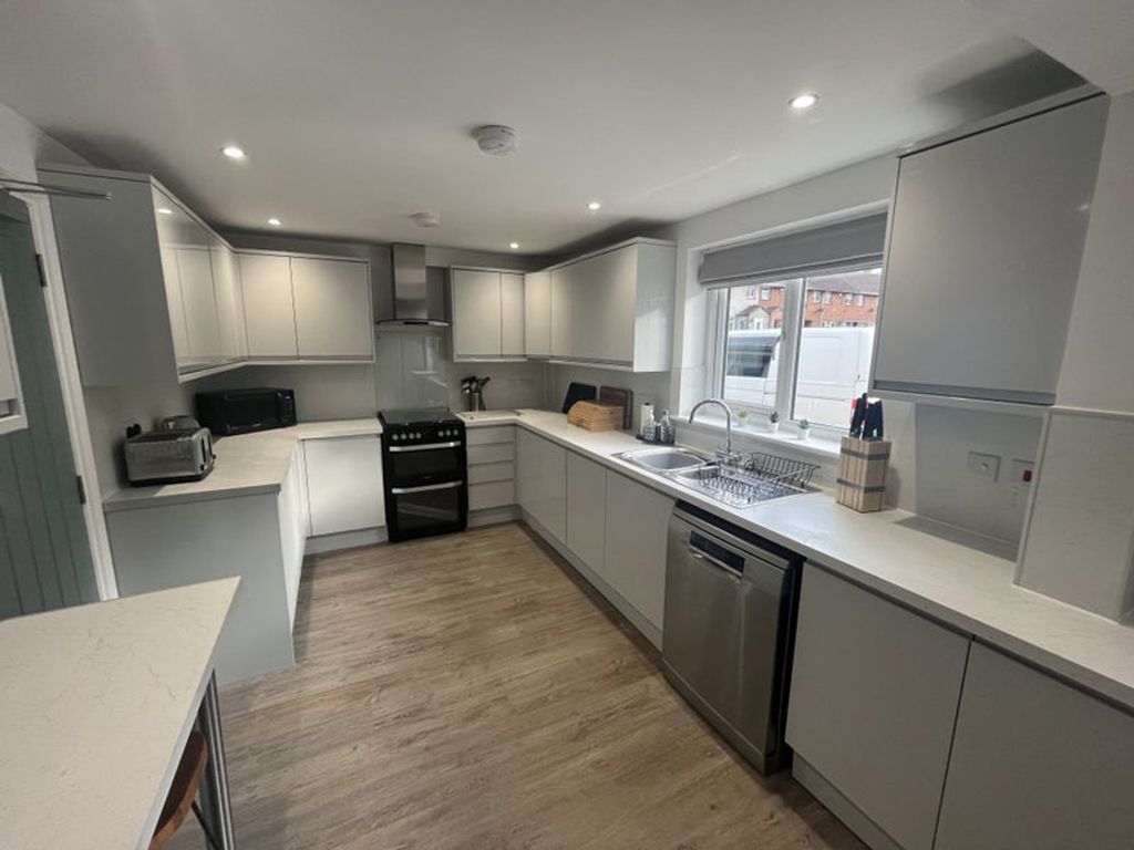 Property photo 3 of 6 Modern And Spacious Kitchen Featuring Sleek Cabine...