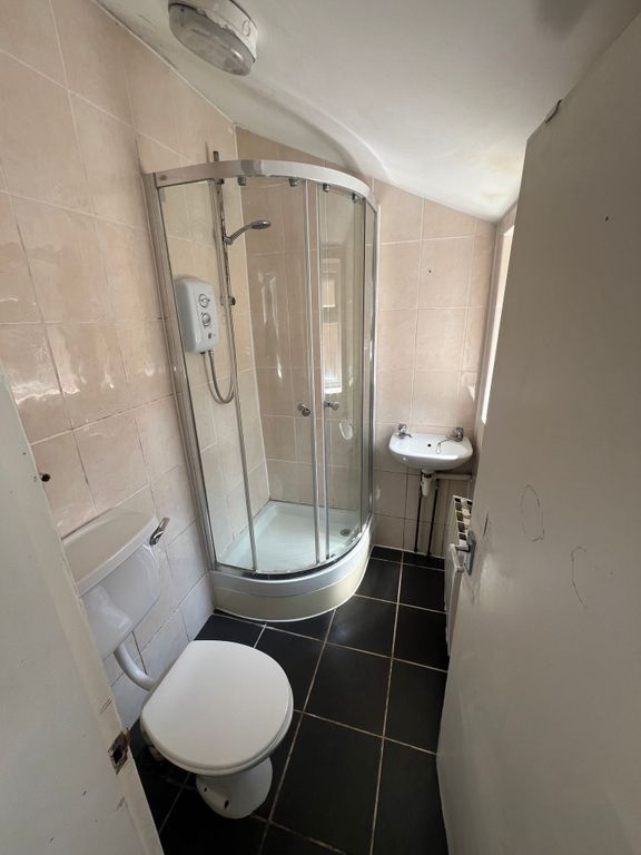 Property photo 3 of 8 Compact Bathroom Featuring A Modern Curved Glass S...