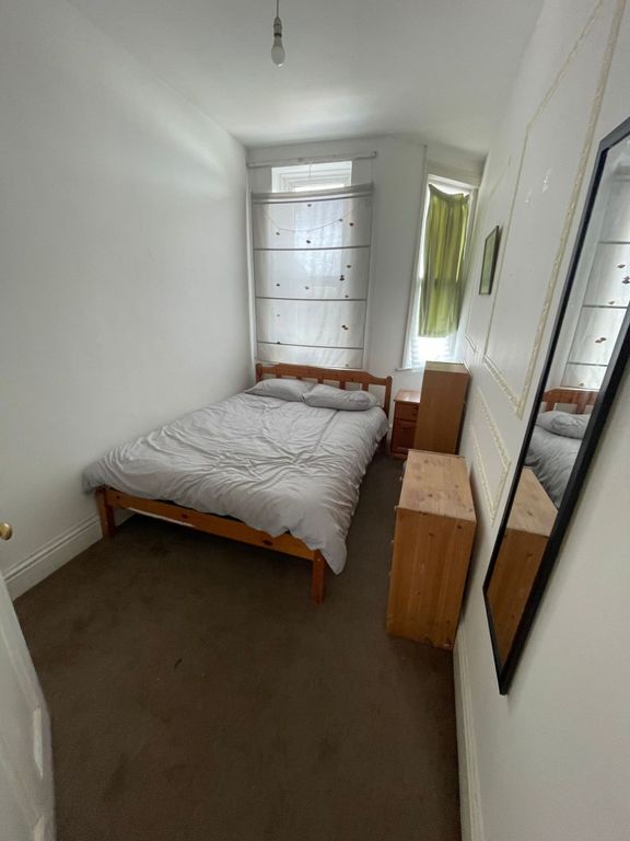 Property photo 2 of 9 A Cozy Single Bedroom Featuring A Wooden Bed Frame...