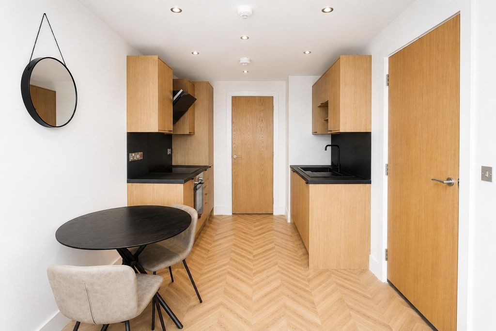 Property photo 3 of 8 Modern Kitchen With Dining Area And Wood Floors...