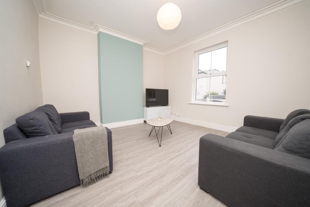 Property photo 3 of 10 A Modern Living Room Featuring Two Comfortable Sof...