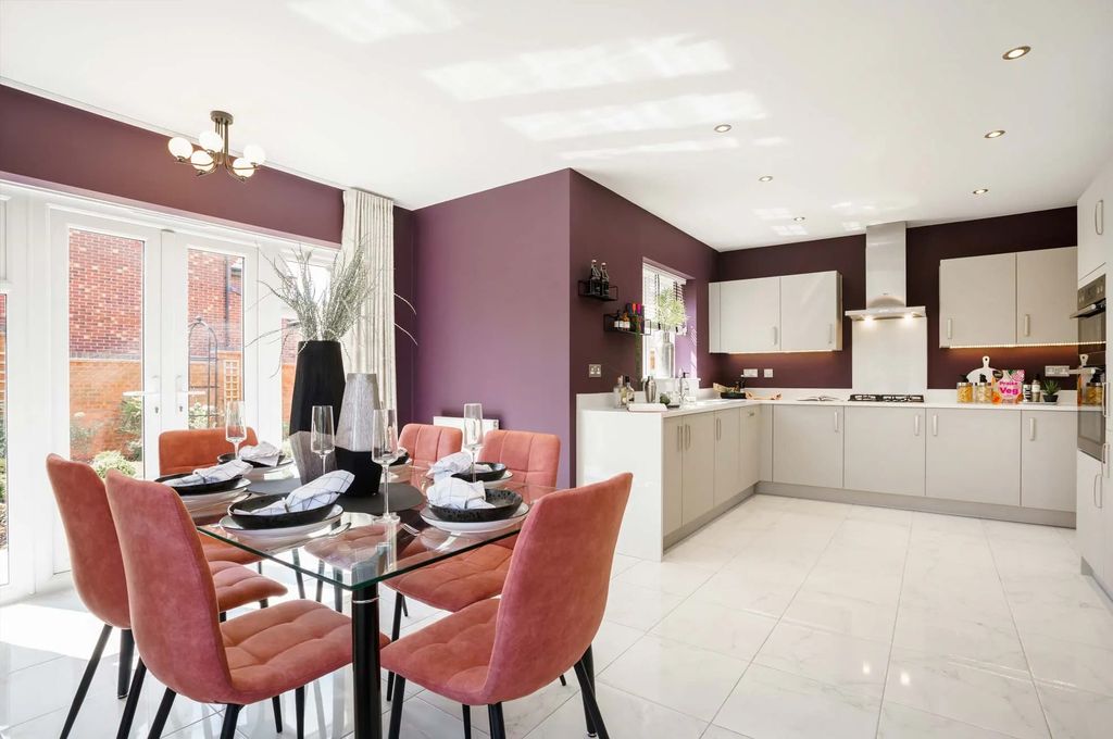 Property photo 2 of 10 A Modern And Stylish Kitchen And Dining Area With A Glass-Topped Table Surrounded By Plush Pink Chai