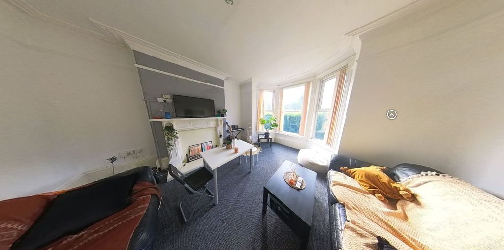 Property photo 3 of 7 A Cozy Living Room With A Bay Window Providing Amp...