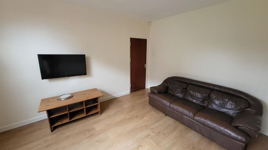 Property photo 2 of 13 Spacious And Well-Lit Living Room Featuring A Larg...