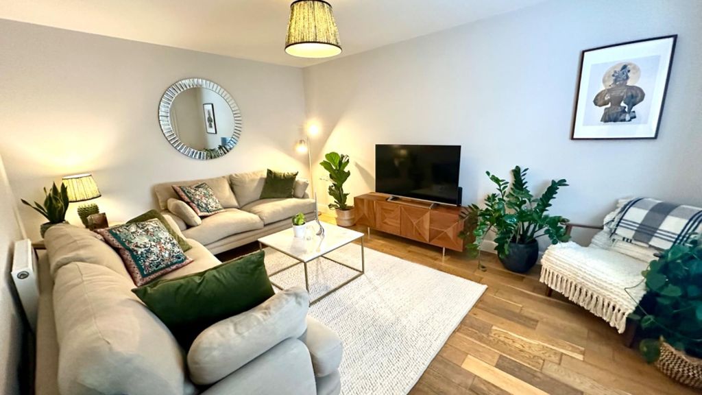 Property photo 2 of 11 Elegant Living Room With Chic Decor And Plants...