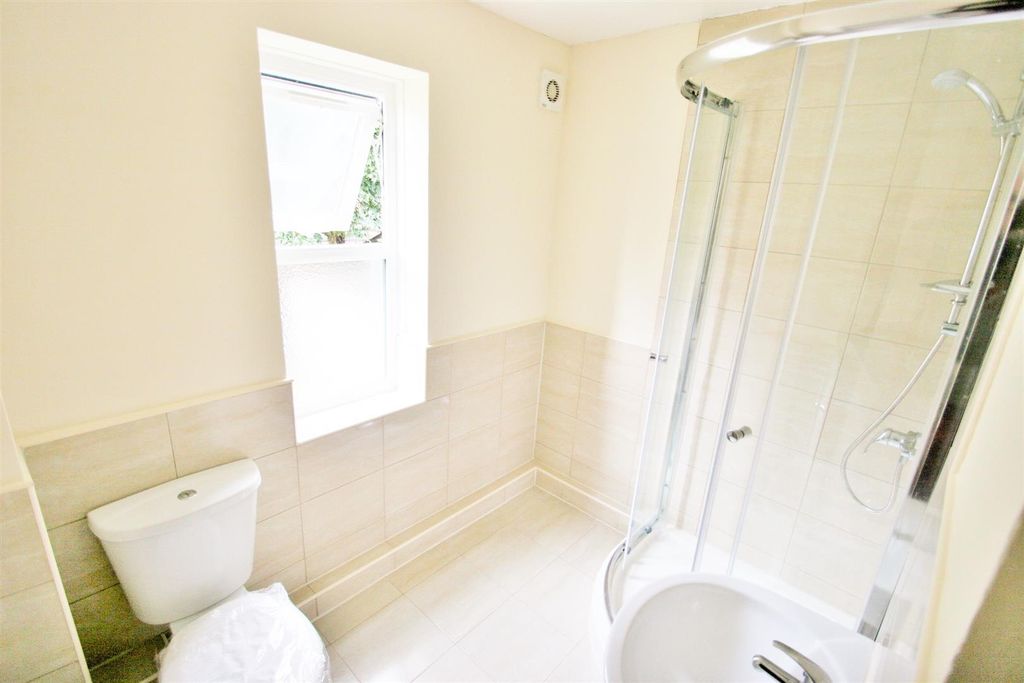 Property photo 3 of 6 Bright And Clean Bathroom Featuring A Modern Showe...