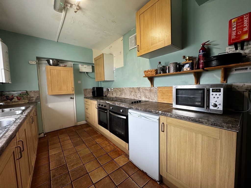 Property photo 3 of 6 Long Galley Kitchen With Wood-Effect Cabinets, Gra...