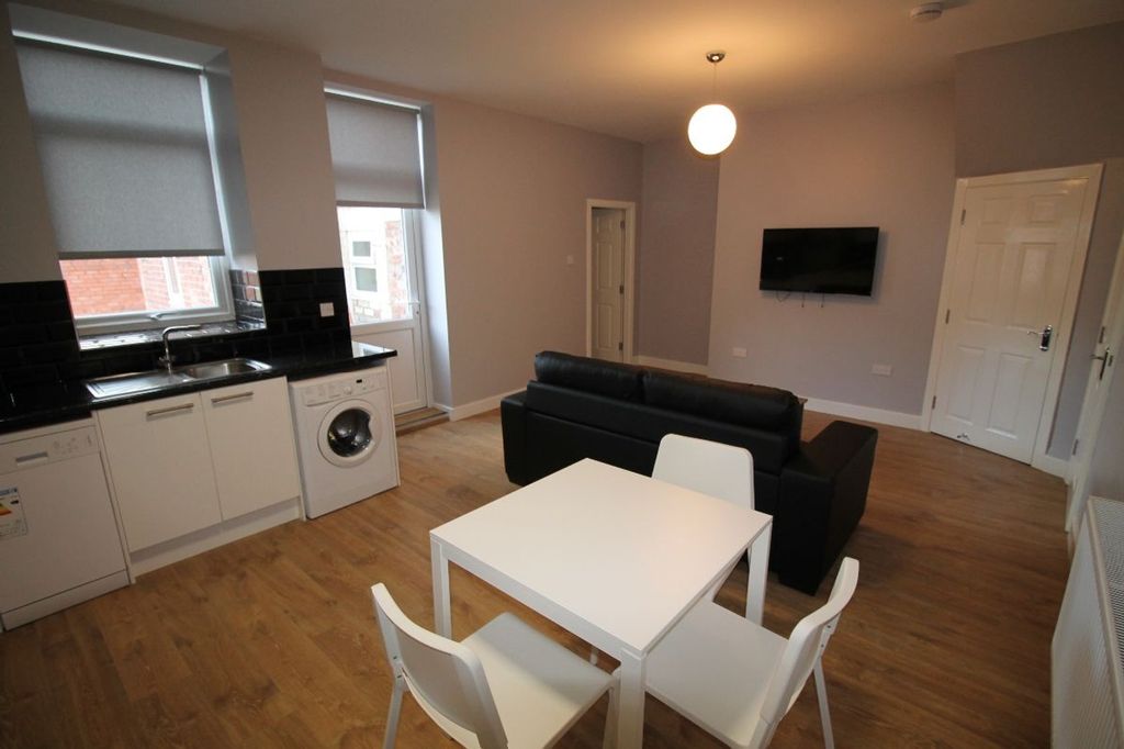 Property photo 3 of 11 Bright And Modern Living Room Featuring A Stylish ...