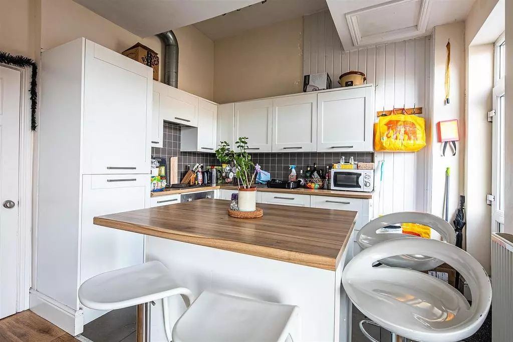 Property photo 2 of 9 Bright And Modern Kitchen Featuring White Cabinetr...
