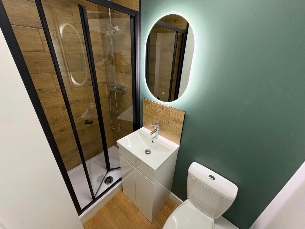 Property photo 3 of 12 A Modern Bathroom Suite Featuring A Glass-Enclosed...