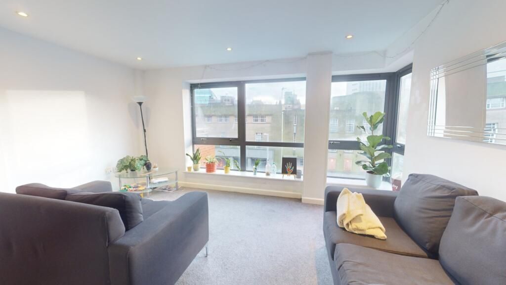Property photo 1 of 5 Bright And Inviting Living Room Featuring Large Wi...