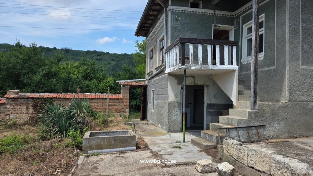Property photo 3 of 72 Two-Storey House With Stairs, Balcony, Brick And Stone Fence, Concrete Path, And Plants In Yard.