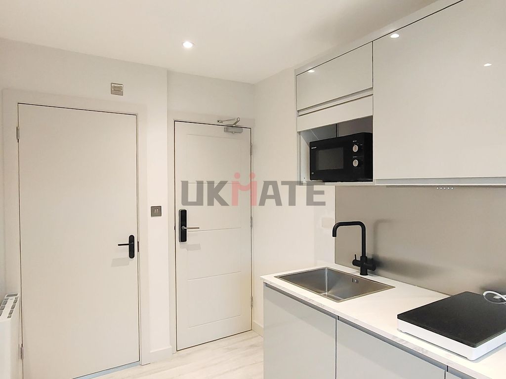 Property photo 3 of 7 Modern And Minimalist Kitchen With White Cabinetry...