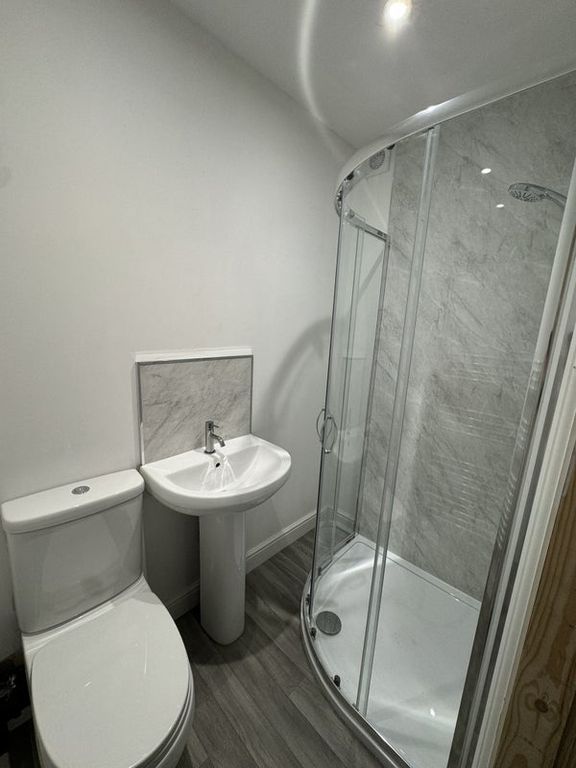 Property photo 3 of 11 A Modern Bathroom Featuring A Curved Glass Shower ...