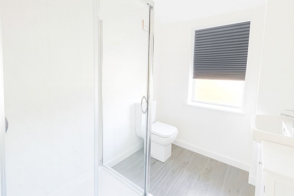 Property photo 3 of 4 Bright And Modern Bathroom With A Clean, Sleek Sho...