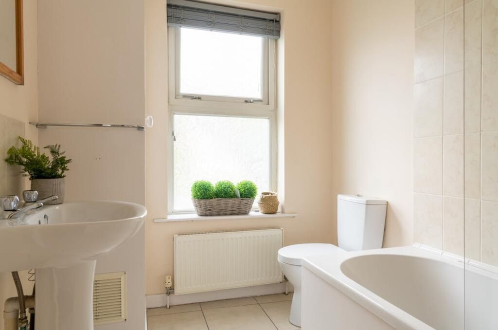 Property photo 3 of 7 Bright And Spacious Bathroom Suite Featuring A Rel...