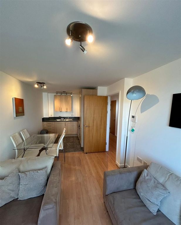 Property photo 2 of 7 Bright Open-Plan Lounge And Dining Area...