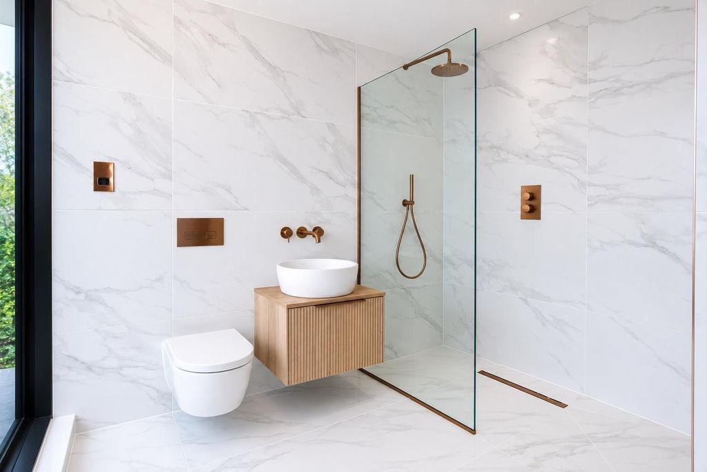 Property photo 3 of 10 Elegant Marble Bathroom With Sleek Brass Accents...