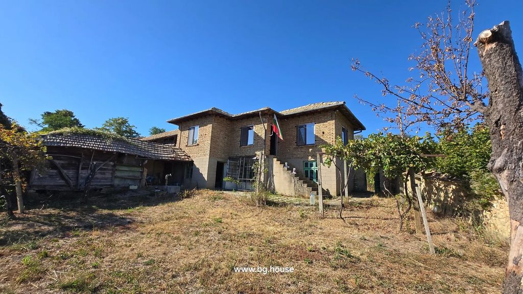 Property photo 2 of 90 Wide View Of Two-Story Brick House With Tiled Roof And External Staircase, Dry Grass And Trees In The Garden Under Clear Blue Sky