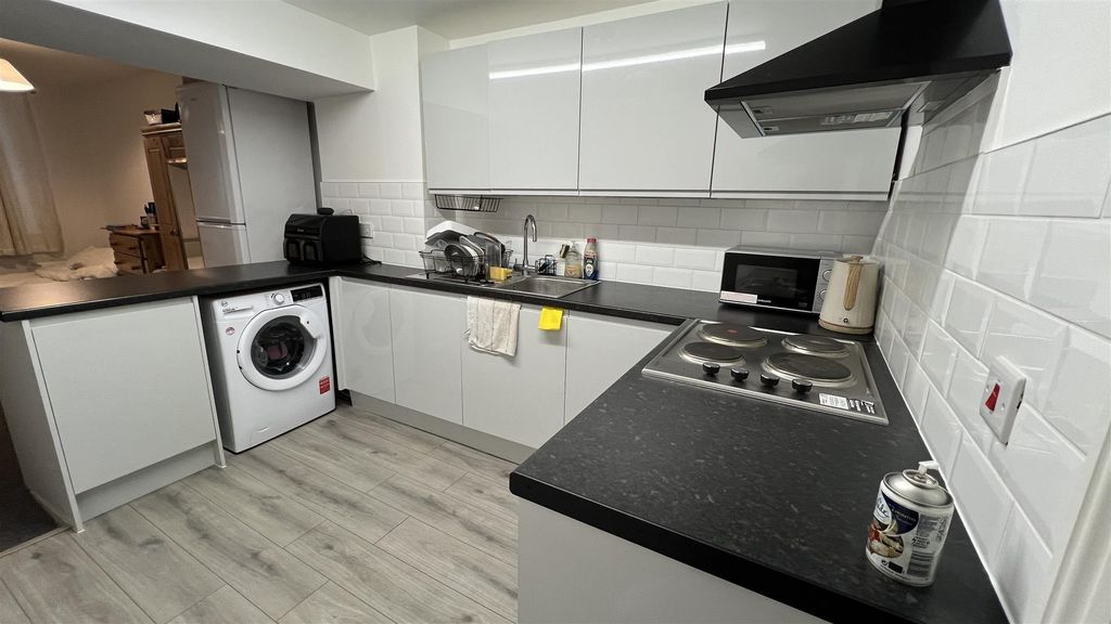 Property photo 3 of 12 Modern Kitchen With Sleek White Cabinetry...