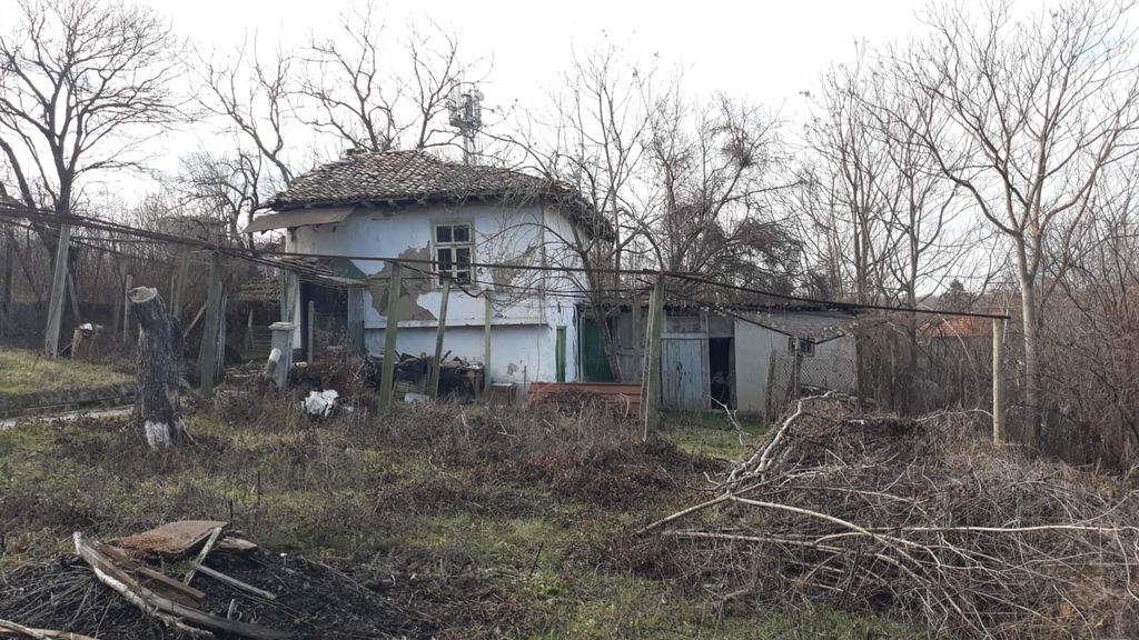 Property photo 1 of 46 View Of A Small Traditional Bulgarian House With Peeling White Walls And A Tiled Roof In A Natural Garden Setting