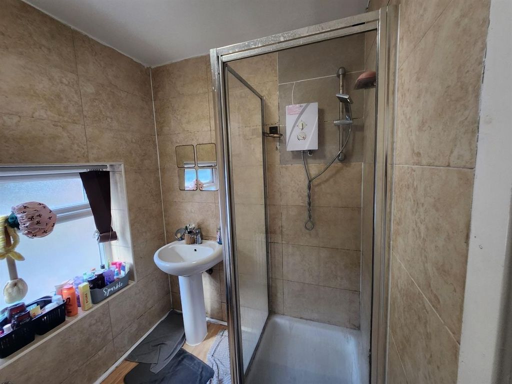 Property photo 3 of 12 A Well-Maintained Bathroom Featuring A Shower With...
