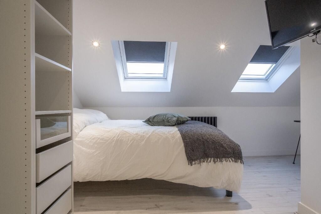 Property photo 3 of 15 A Spacious, Well-Lit Master Bedroom Featuring Larg...