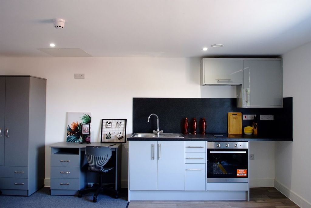 Property photo 3 of 6 This Modern Kitchen Features Sleek Cabinetry And A...
