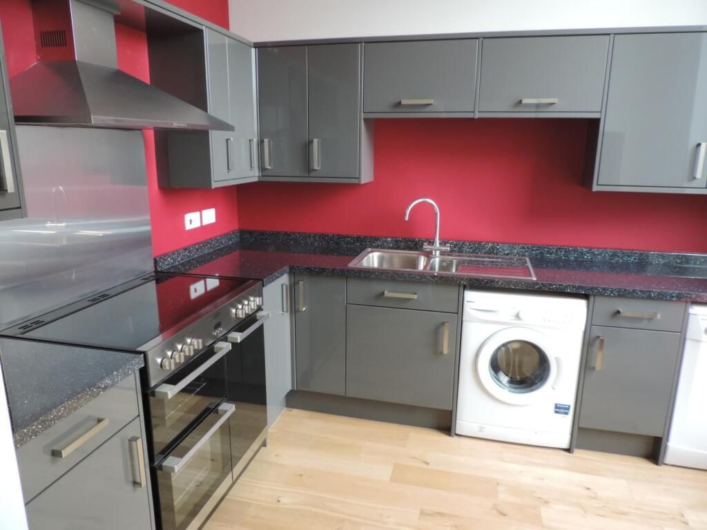 Property photo 1 of 4 Modern Kitchen With Sleek Grey Units And Red Wall...