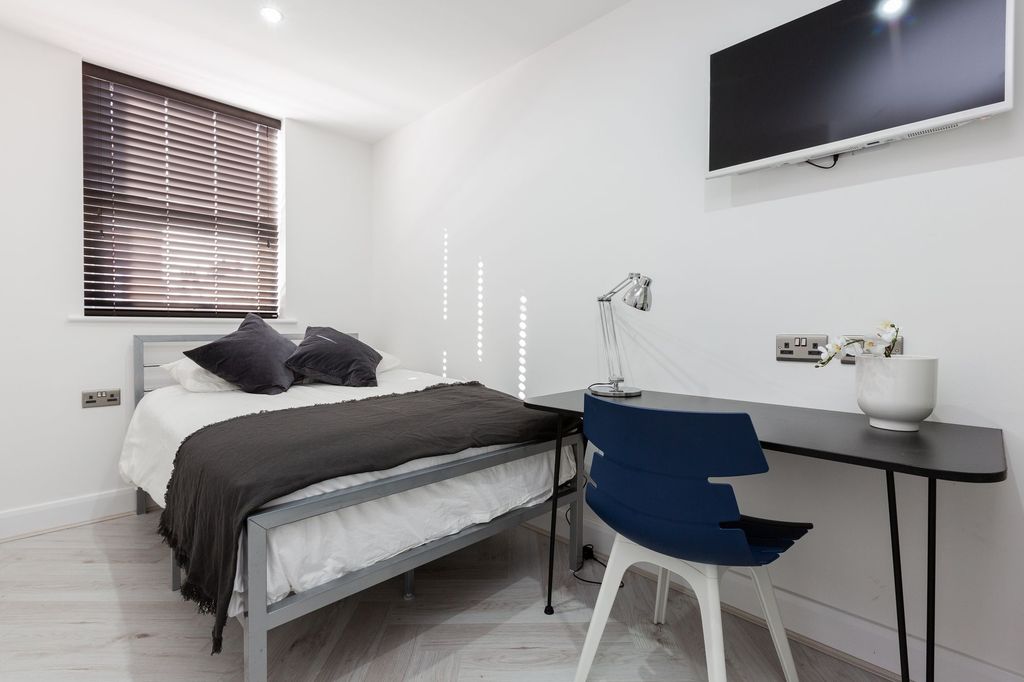 Property photo 1 of 12 A Modern, Tidy Bedroom Featuring A Comfortable Bed...