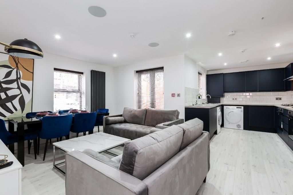 Property photo 3 of 15 A Spacious And Modern Living Room Featuring Contem...