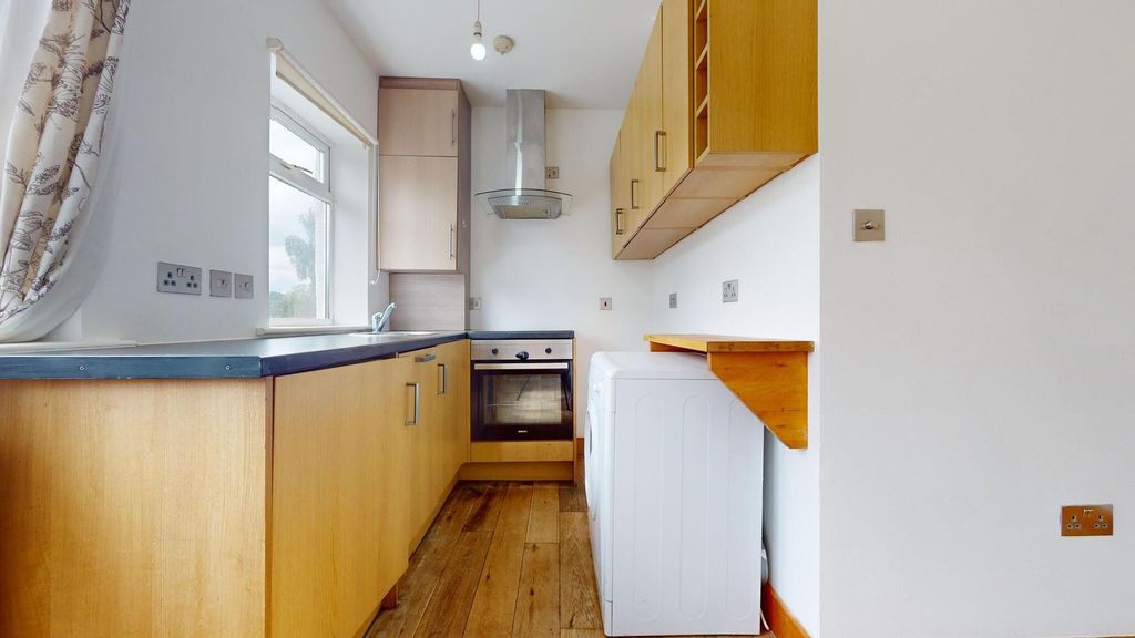 Property photo 3 of 12 Bright And Functional Kitchen With Ample Natural l...