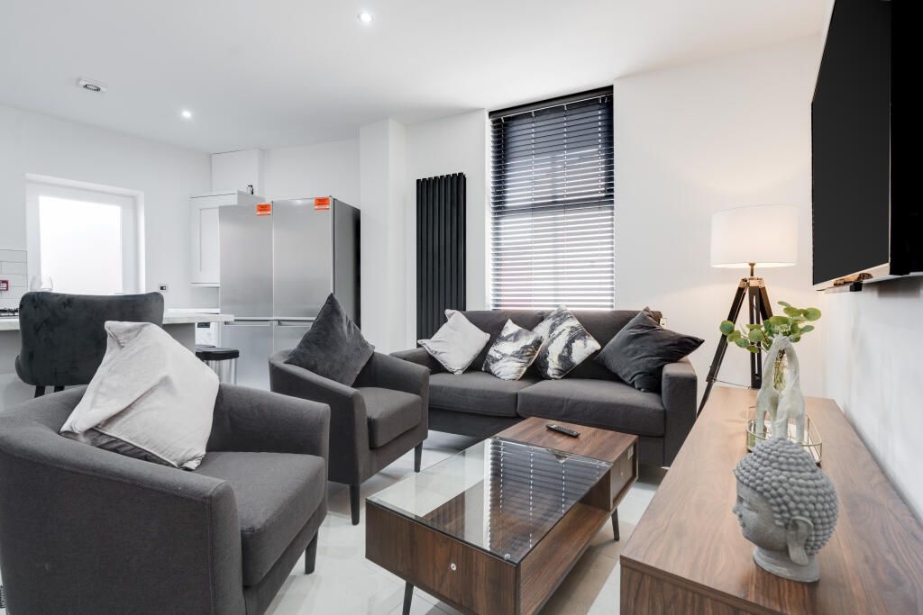 Property photo 3 of 13 A Spacious, Modern Living Room Featuring Comfortab...